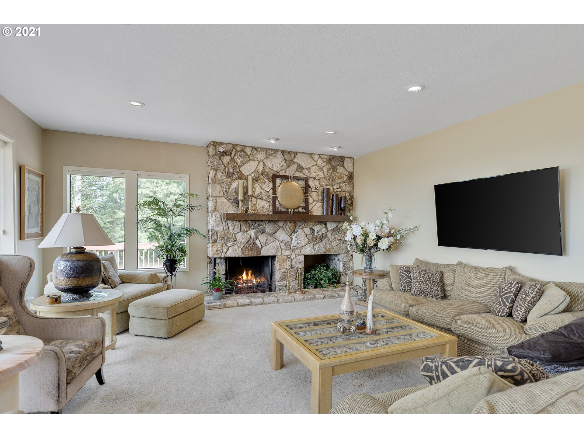 201 Northeast Salzman Road Corbett, OR 97019 - Photo 9 of 32 a living room with furniture a flat screen tv and a fireplace