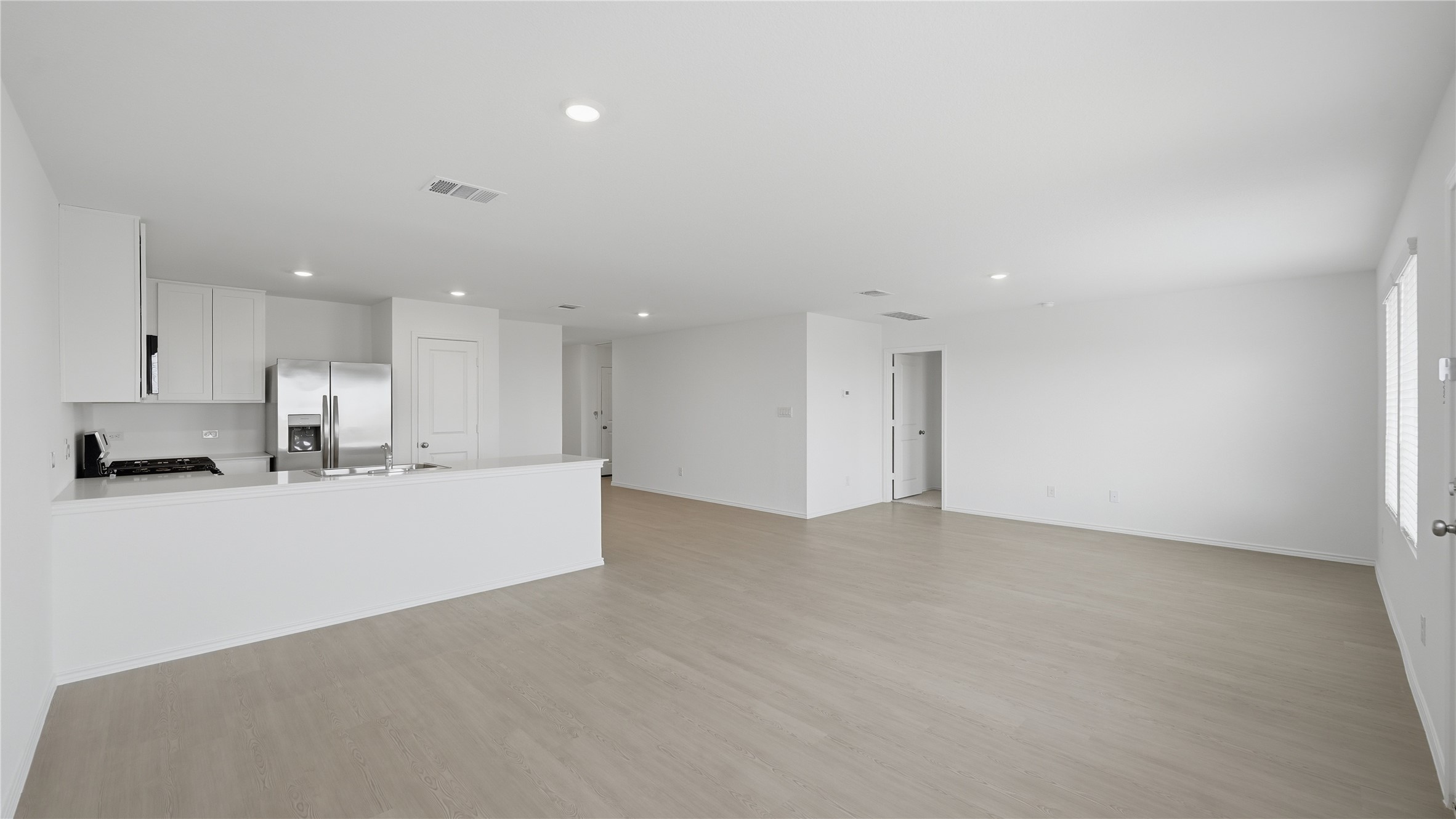 221 Stumpy Street San Marcos, TX 78666 - Photo 10 of 35 a view of kitchen with kitchen island white cabinetry and refrigerator