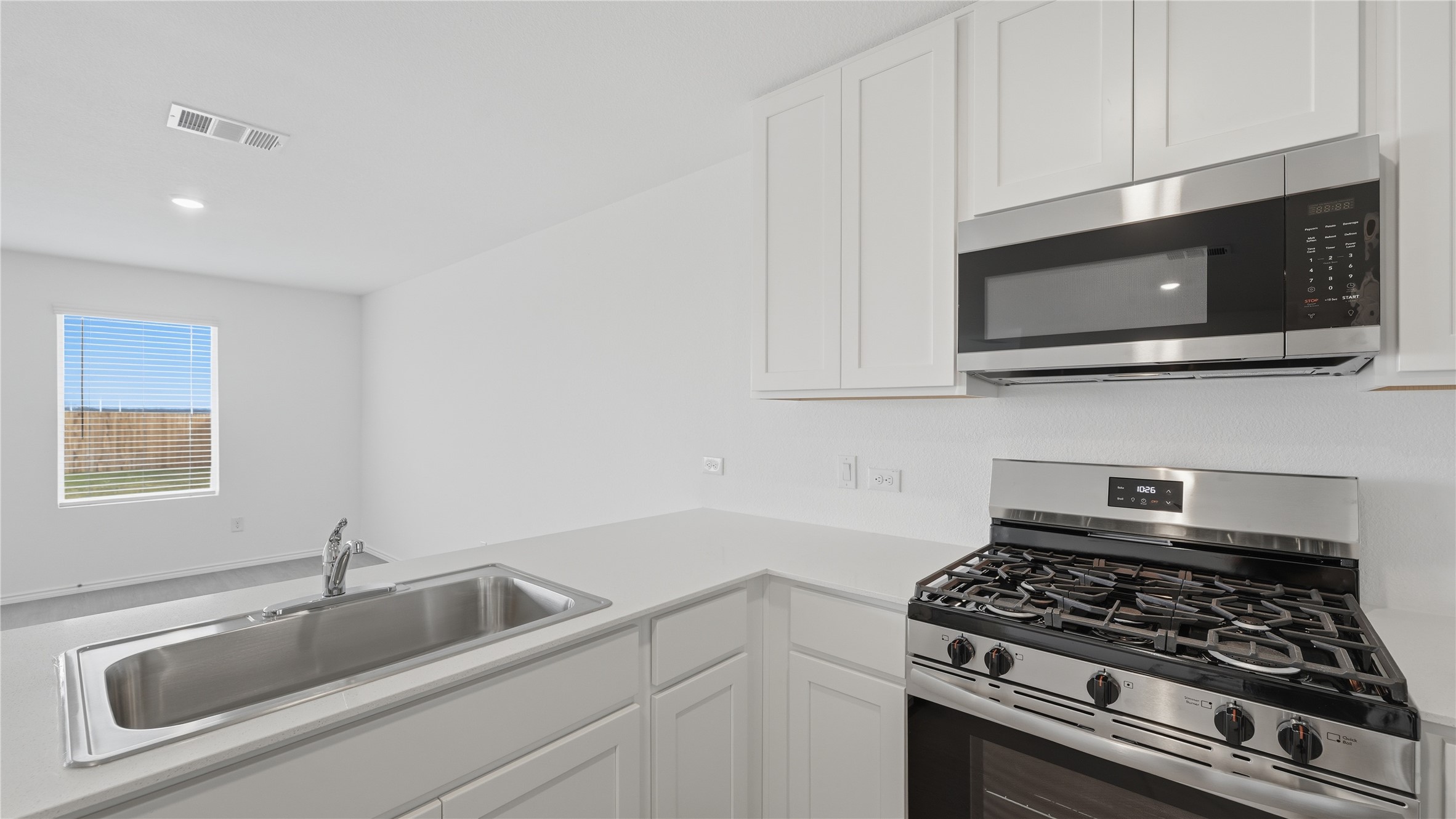 221 Stumpy Street San Marcos, TX 78666 - Photo 3 of 35 a kitchen with granite countertop a sink stainless steel appliances and cabinets
