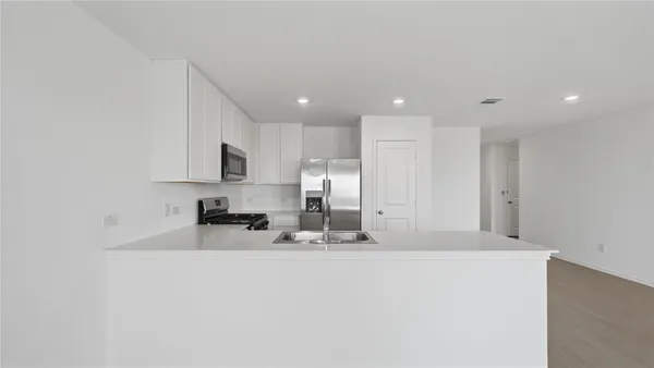 a large white kitchen with a sink
