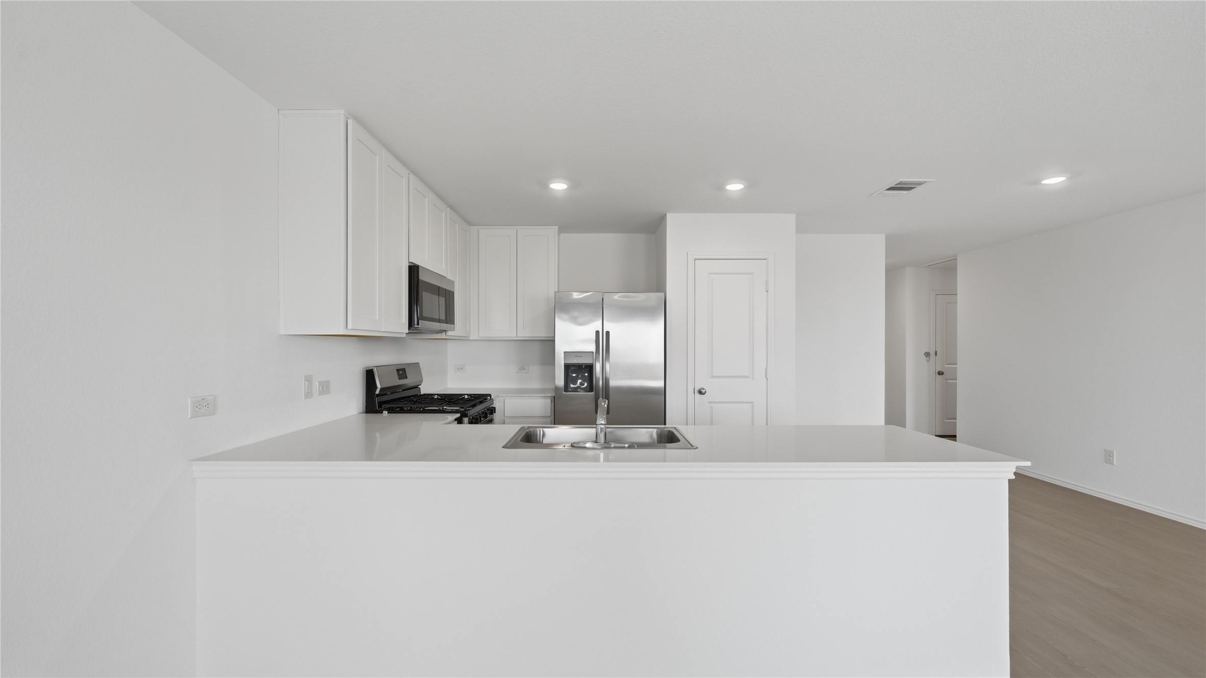 221 Stumpy Street San Marcos, TX 78666 - Photo 4 of 35 a large white kitchen with a sink