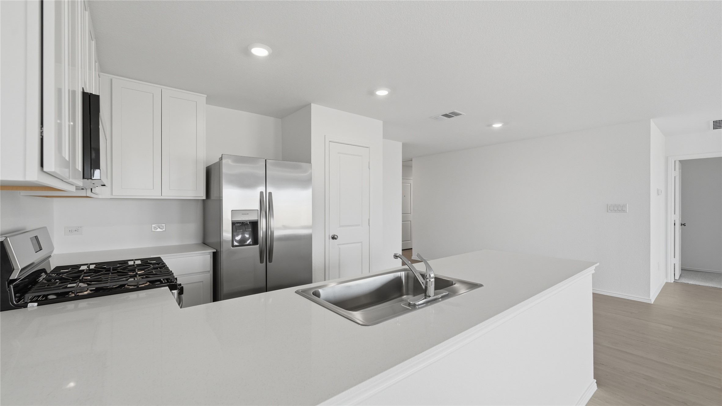221 Stumpy Street San Marcos, TX 78666 - Photo 5 of 35 a kitchen with stainless steel appliances a sink a stove a refrigerator and cabinets