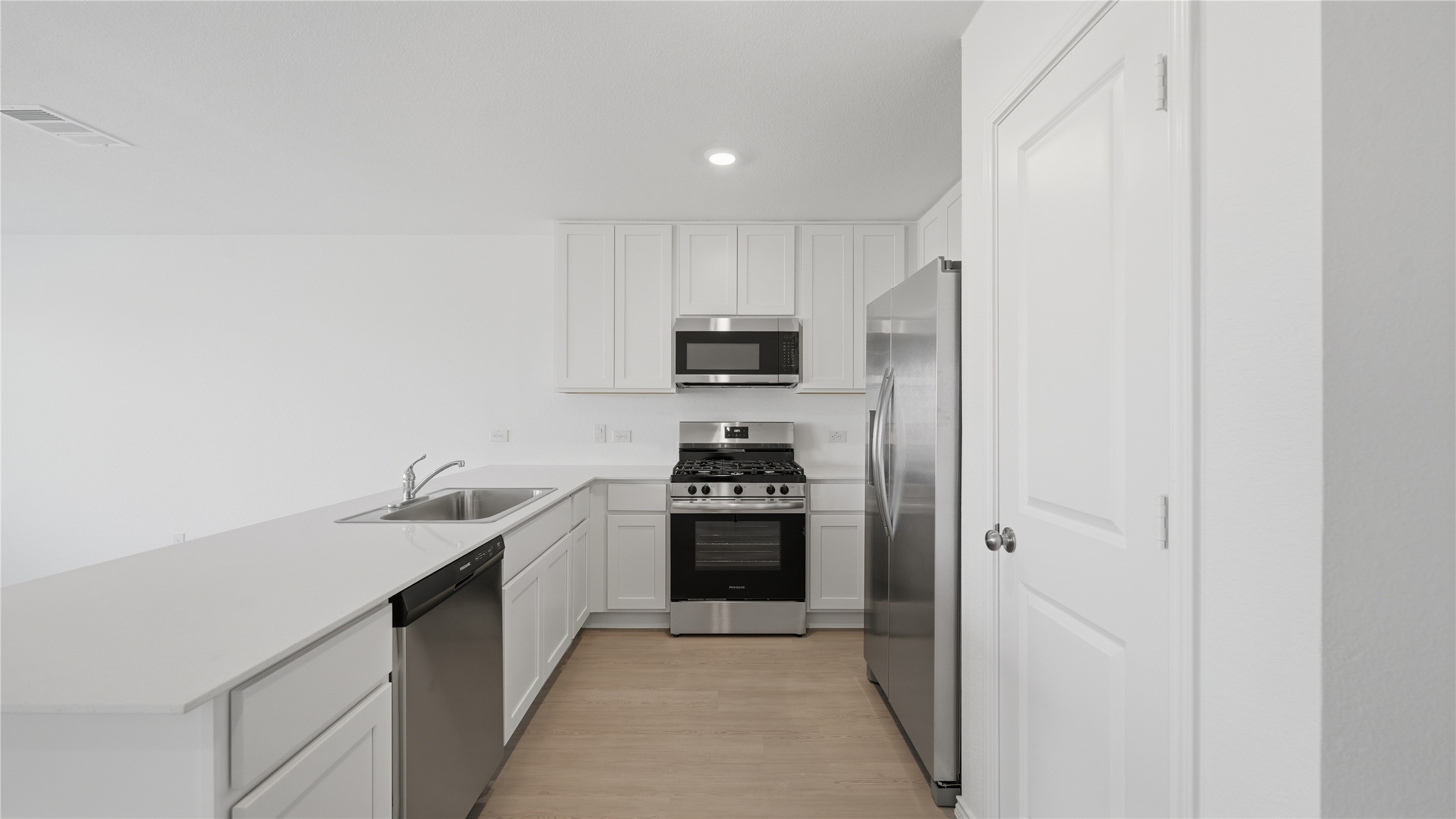 221 Stumpy Street San Marcos, TX 78666 - Photo 7 of 35 a kitchen with stainless steel appliances granite countertop a refrigerator and a sink