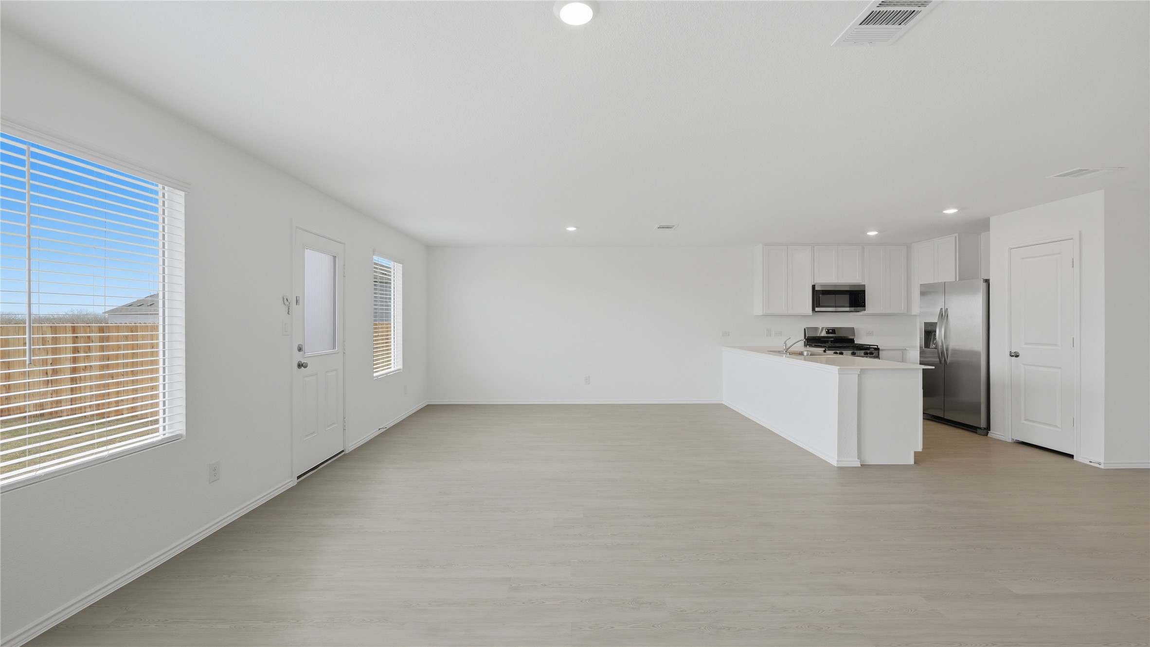 221 Stumpy Street San Marcos, TX 78666 - Photo 9 of 35 a view of a kitchen with refrigerator and white cabinets