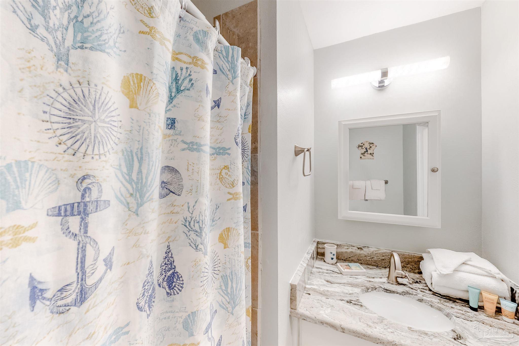 14580 Perdido Key Drive, Unit C3 Perdido Key, FL 32507 - Photo 12 of 17 a bedroom with a bed and a mirror