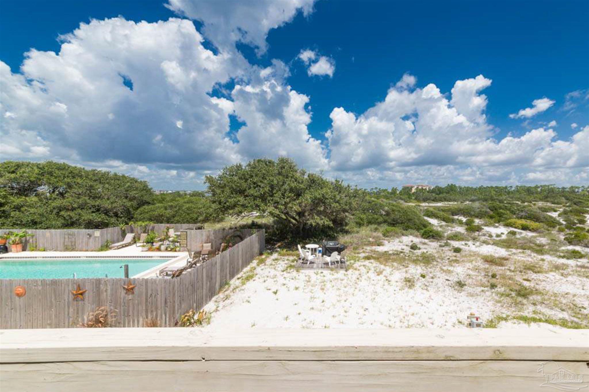 14580 Perdido Key Drive, Unit C3 Perdido Key, FL 32507 - Photo 15 of 17 a view of a yard with flower plants