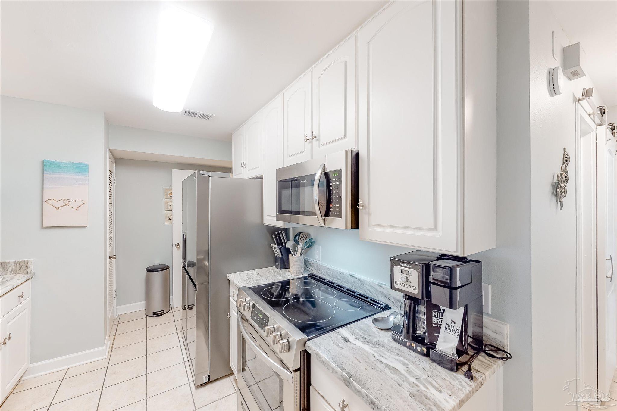 14580 Perdido Key Drive, Unit C3 Perdido Key, FL 32507 - Photo 2 of 17 a kitchen with stainless steel appliances granite countertop a sink and a refrigerator