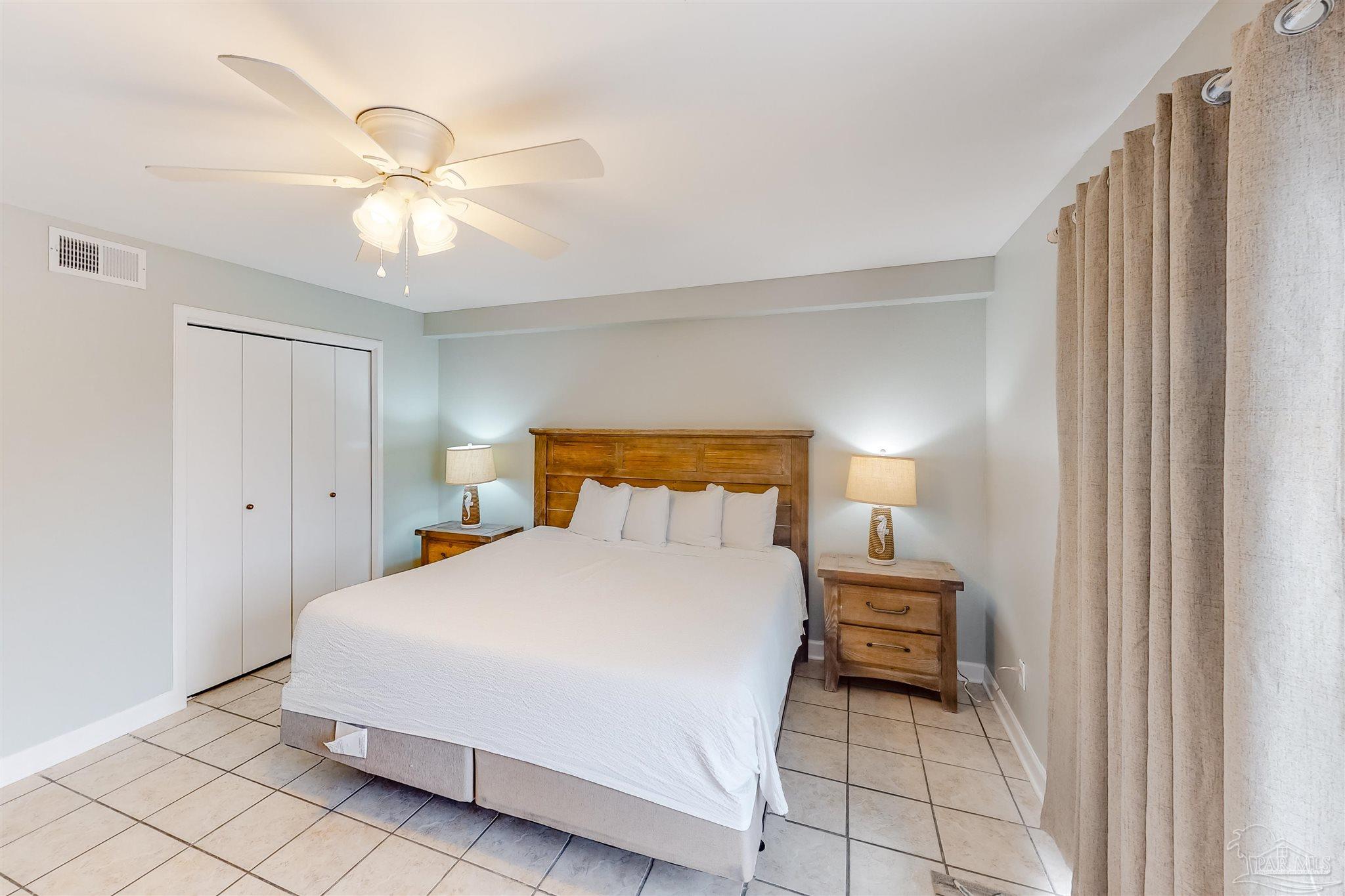 14580 Perdido Key Drive, Unit C3 Perdido Key, FL 32507 - Photo 9 of 17 a bedroom with a bed and a chandelier