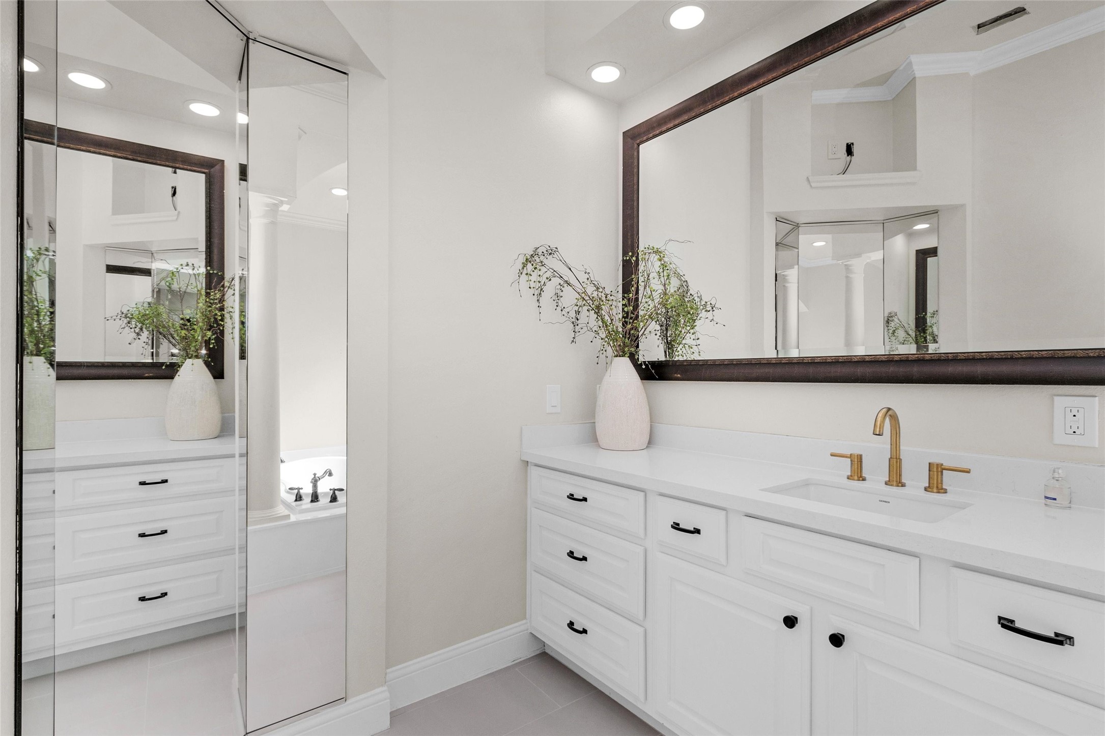 10004 Summer Ridge Lane Conroe, TX 77302 - Photo 28 of 50 a bathroom with a double vanity sink and a mirror