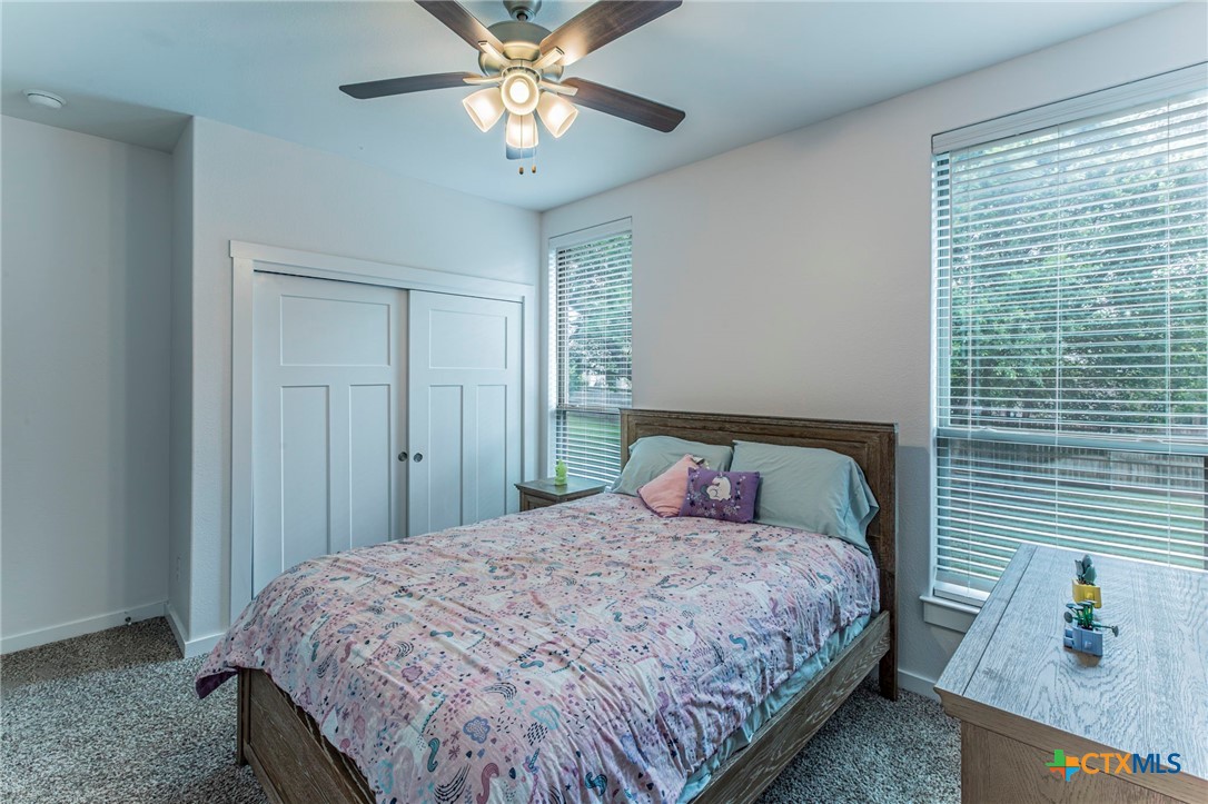 8 Daingerfield Cove Morgan's Point Resort, TX 76513 - Photo 20 of 28 a bedroom with a bed and a chandelier