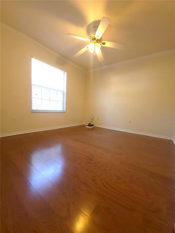 5909 Southwest 86th Drive Gainesville, FL 32608 - Photo 11 of 22 an empty room with wooden floor and windows