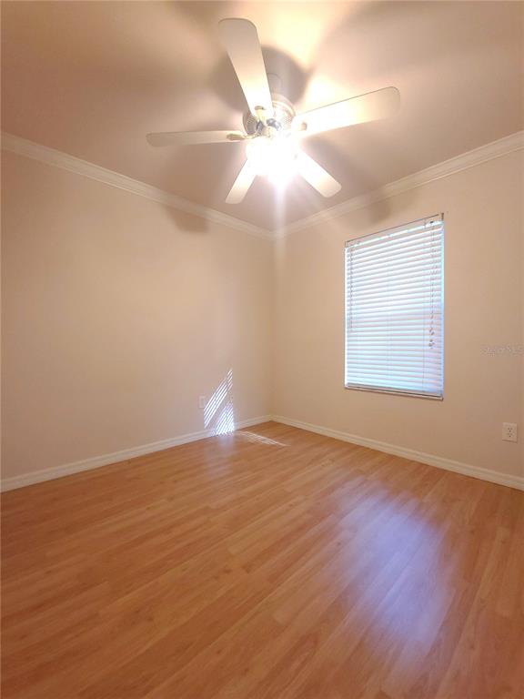 5909 Southwest 86th Drive Gainesville, FL 32608 - Photo 12 of 22 an empty room with wooden floor fan and windows