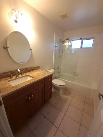 a bathroom with a double vanity sink a toilet and a mirror