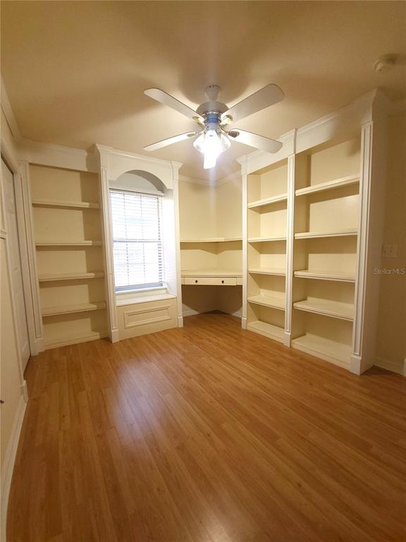 5909 Southwest 86th Drive Gainesville, FL 32608 - Photo 14 of 22 a view of a room with wooden floor and ceiling fan