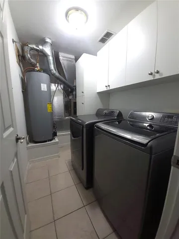 a kitchen with a sink a refrigerator and cabinets