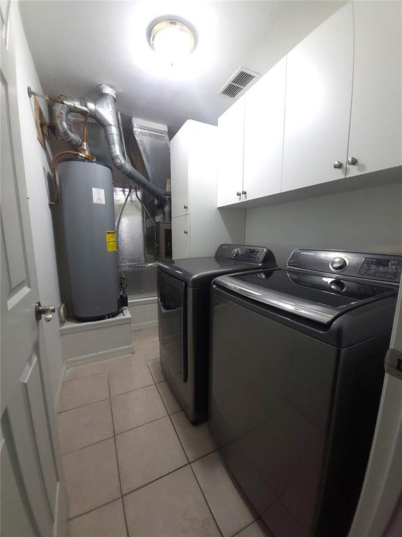 5909 Southwest 86th Drive Gainesville, FL 32608 - Photo 15 of 22 a kitchen with a sink a refrigerator and cabinets