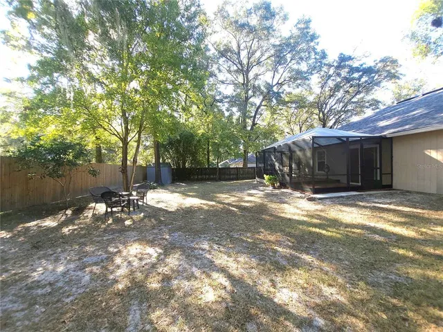 a view of a house with a yard and tree
