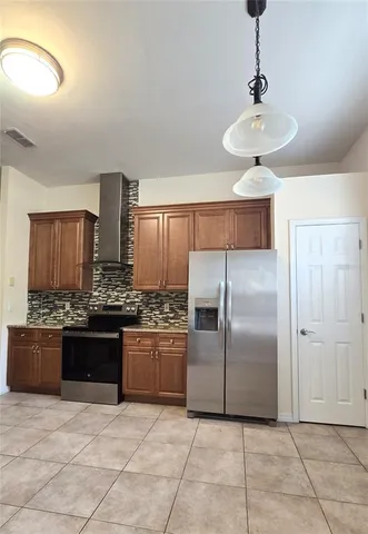 a kitchen with stainless steel appliances granite countertop a stove and a refrigerator