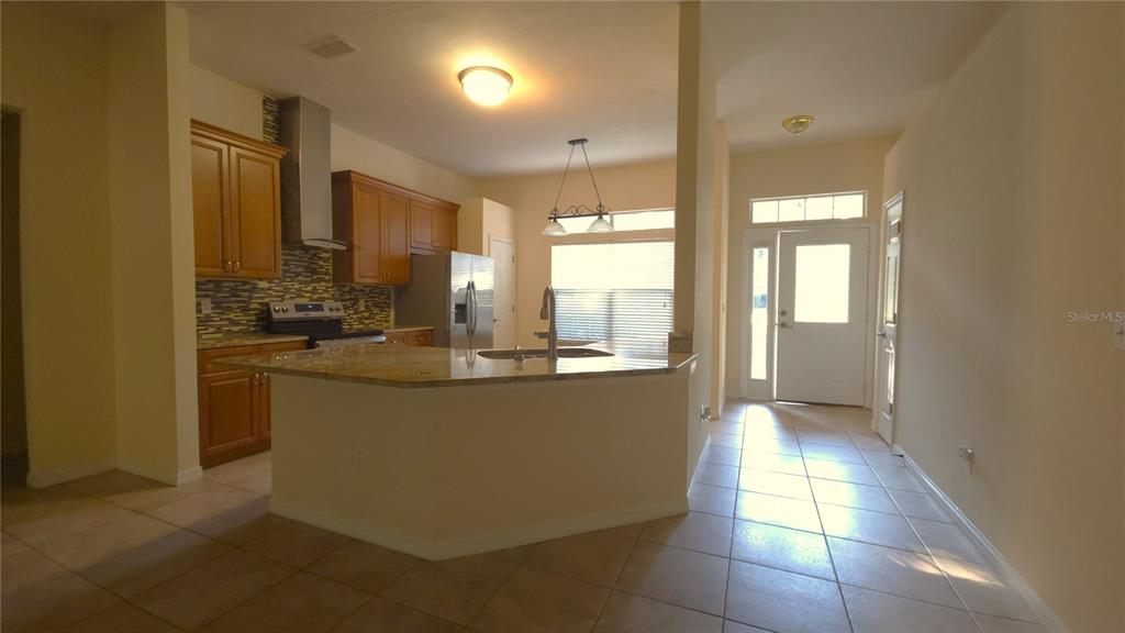 5909 Southwest 86th Drive Gainesville, FL 32608 - Photo 5 of 22 a view of a kitchen with kitchen island granite countertop a large window
