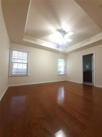 an empty room with windows and closet