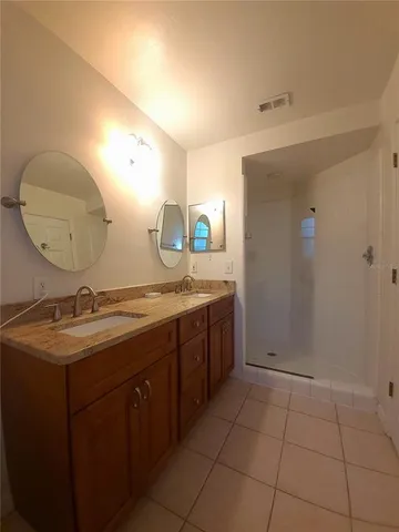 a bathroom with a double vanity sink and mirror