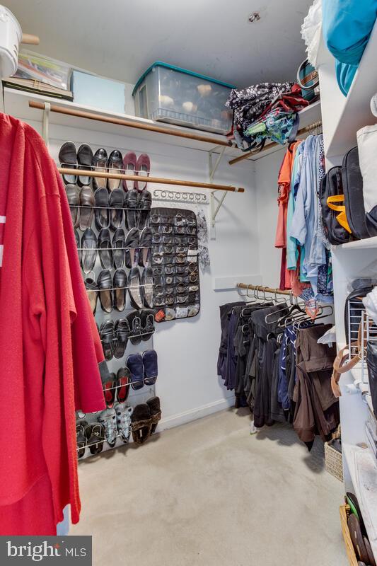 7883 Poplar Grove Road Severn, MD 21144 - Photo 34 of 77 a view of walk in closet with clothes and shoes