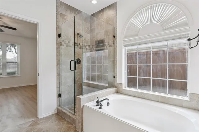 a bathroom with a bathtub and a shower