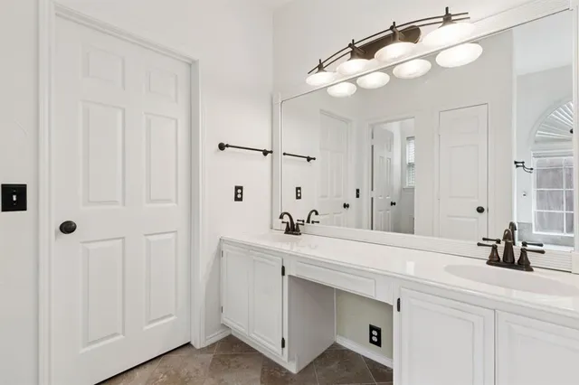 a bathroom with a sink vanity and a mirror