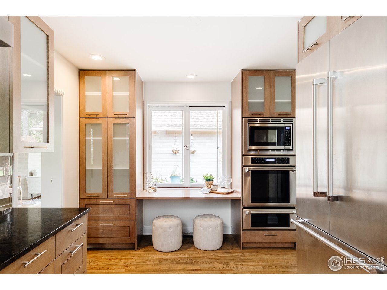 733 13th Street Boulder, CO 80302 - Photo 17 of 35 a kitchen with stainless steel appliances kitchen island granite countertop a refrigerator a stove and a sink with wooden floor