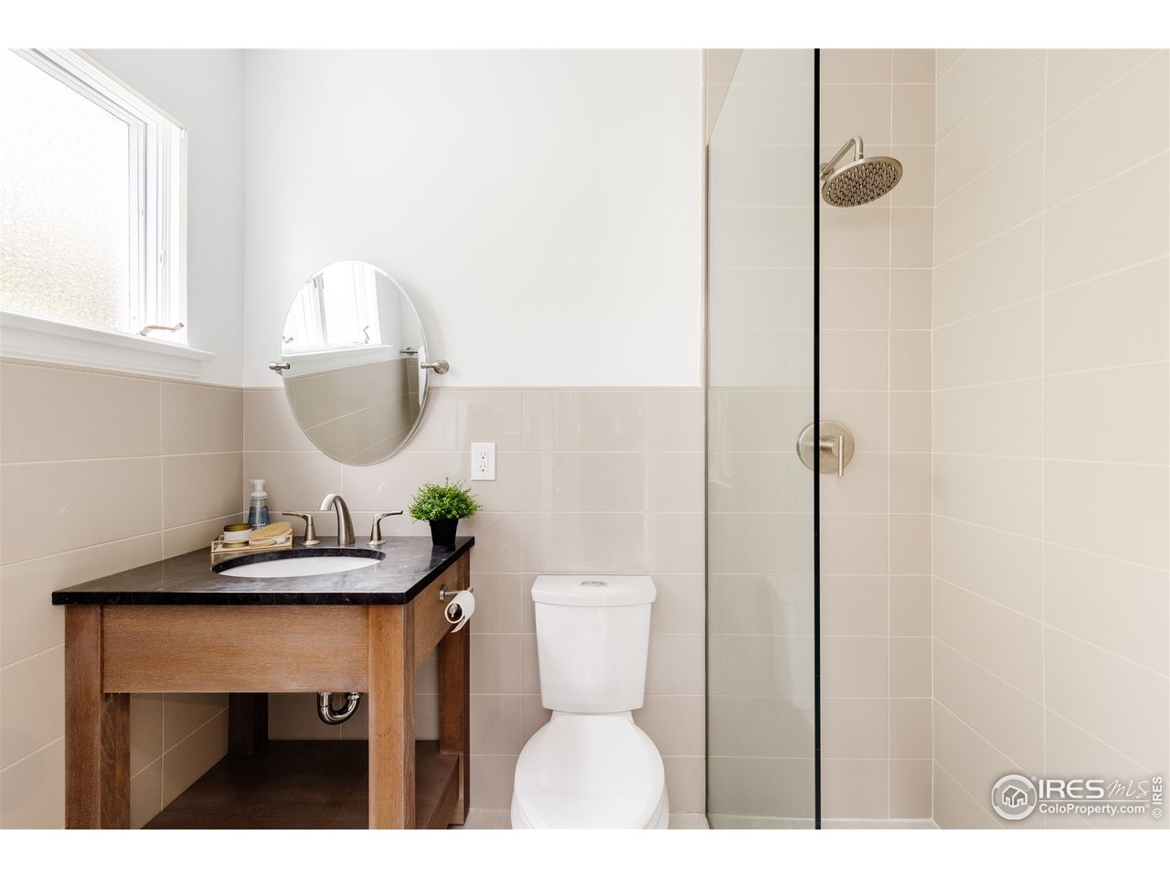733 13th Street Boulder, CO 80302 - Photo 29 of 35 a bathroom with a sink a toilet and a mirror