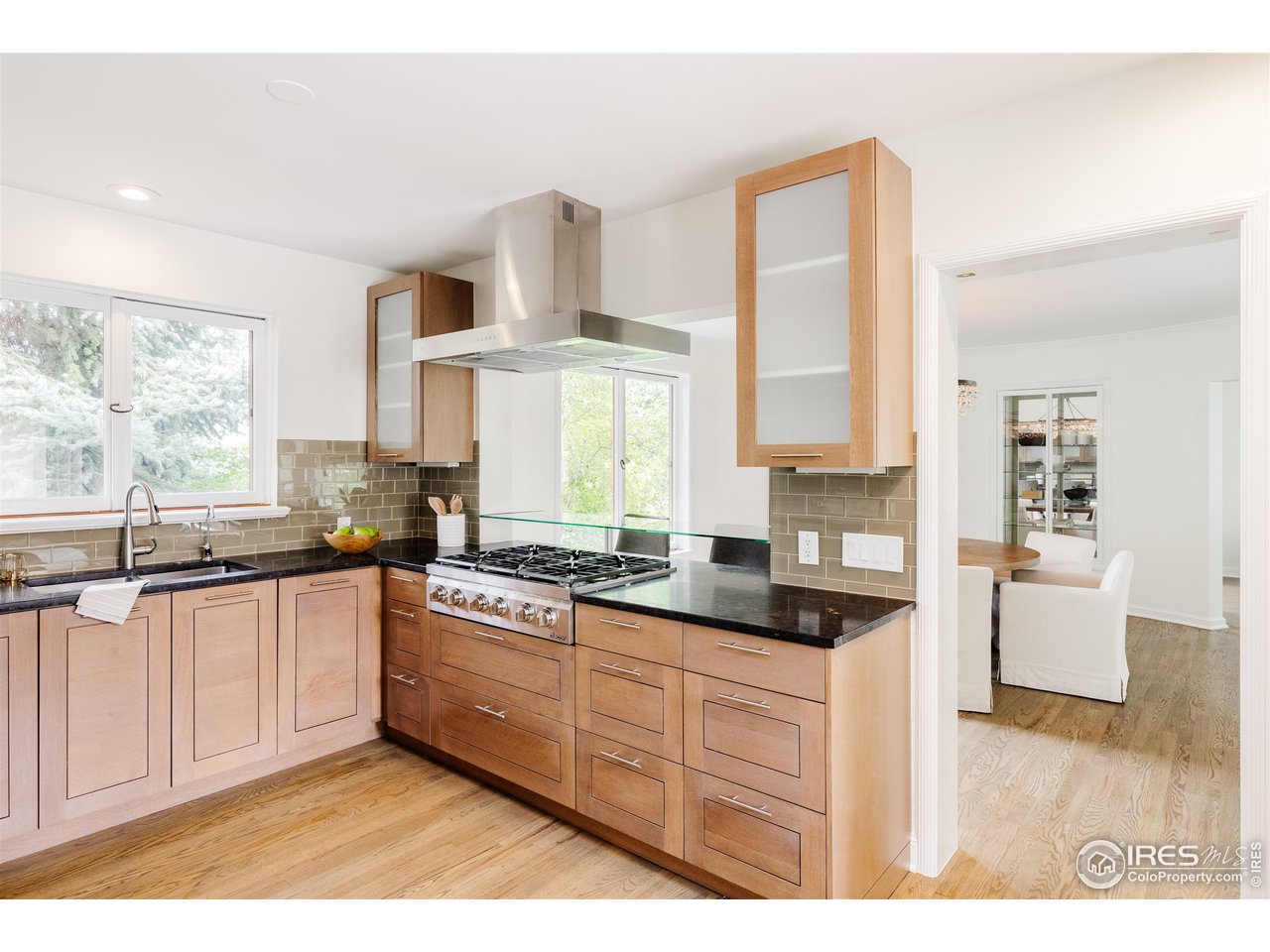 733 13th Street Boulder, CO 80302 - Photo 3 of 35 a kitchen with stainless steel appliances granite countertop a stove a sink and white cabinets