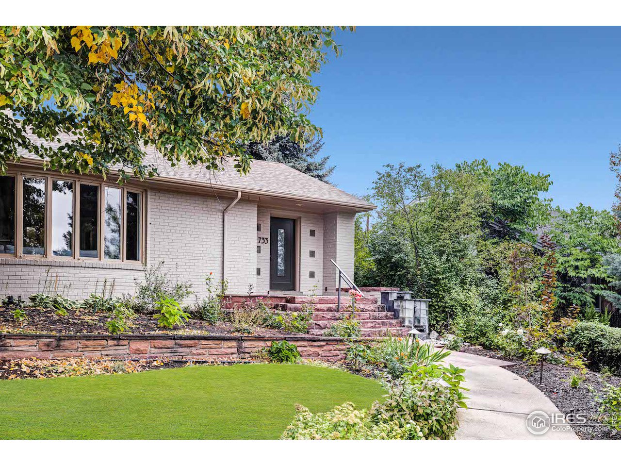 733 13th Street Boulder, CO 80302 - Photo 32 of 35 a front view of a house with a yard