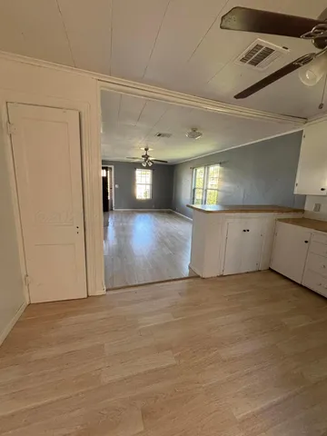 a view of a kitchen with a sink and cabinets