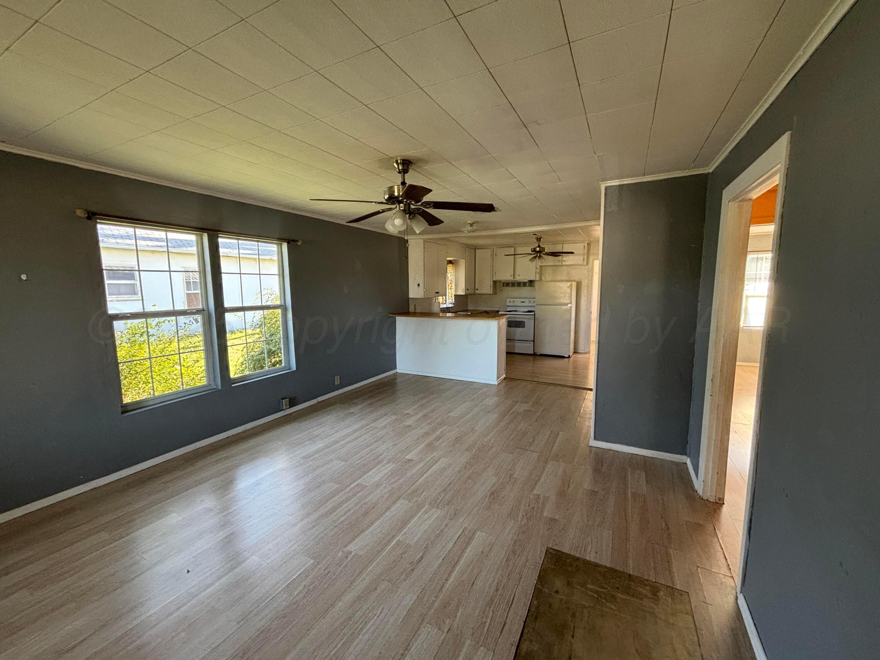 320 West Summit Street Miami, TX 79059 - Photo 17 of 19 a kitchen with a wooden floor and a window