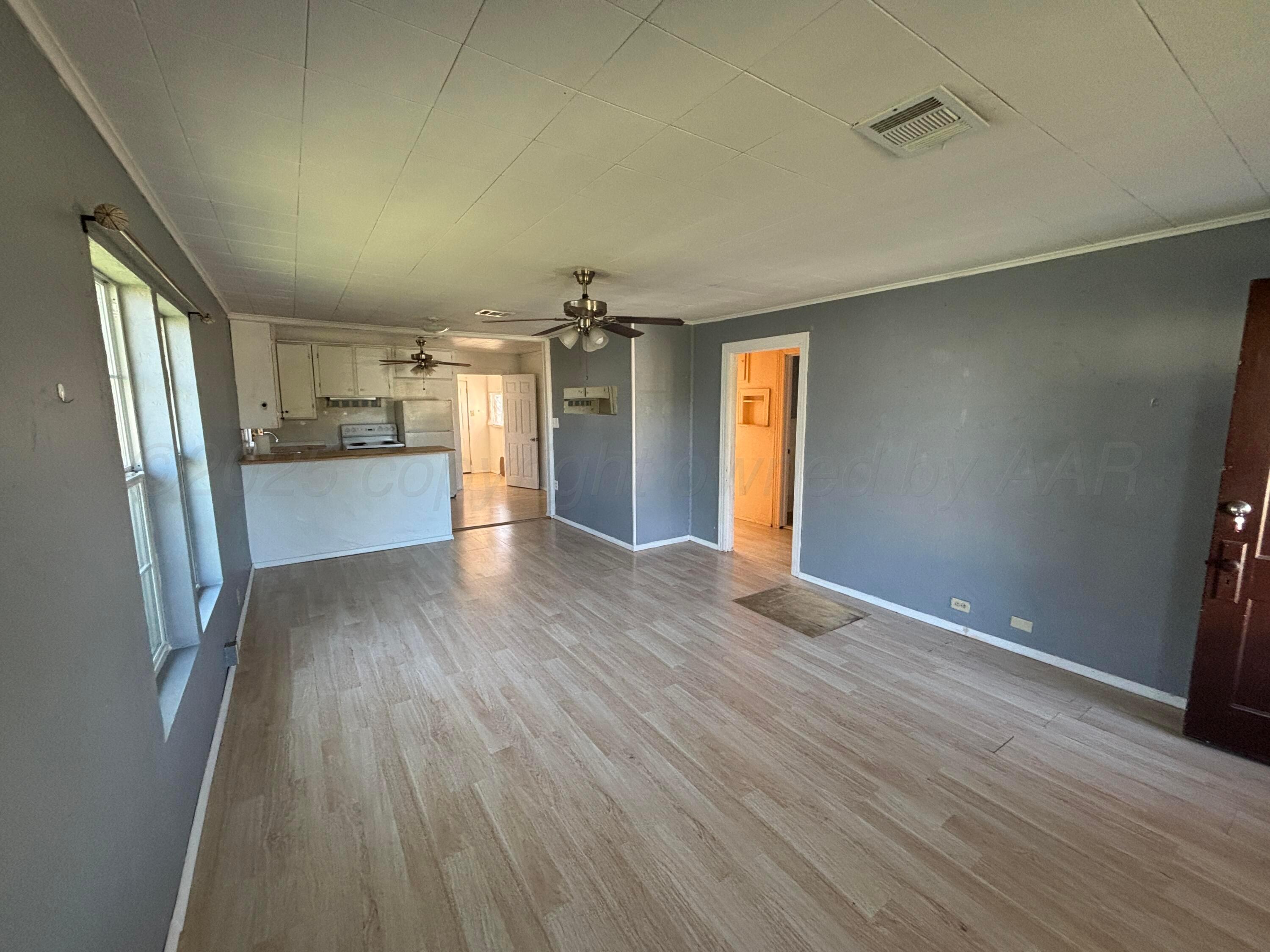 320 West Summit Street Miami, TX 79059 - Photo 18 of 19 an empty room with wooden floor and windows