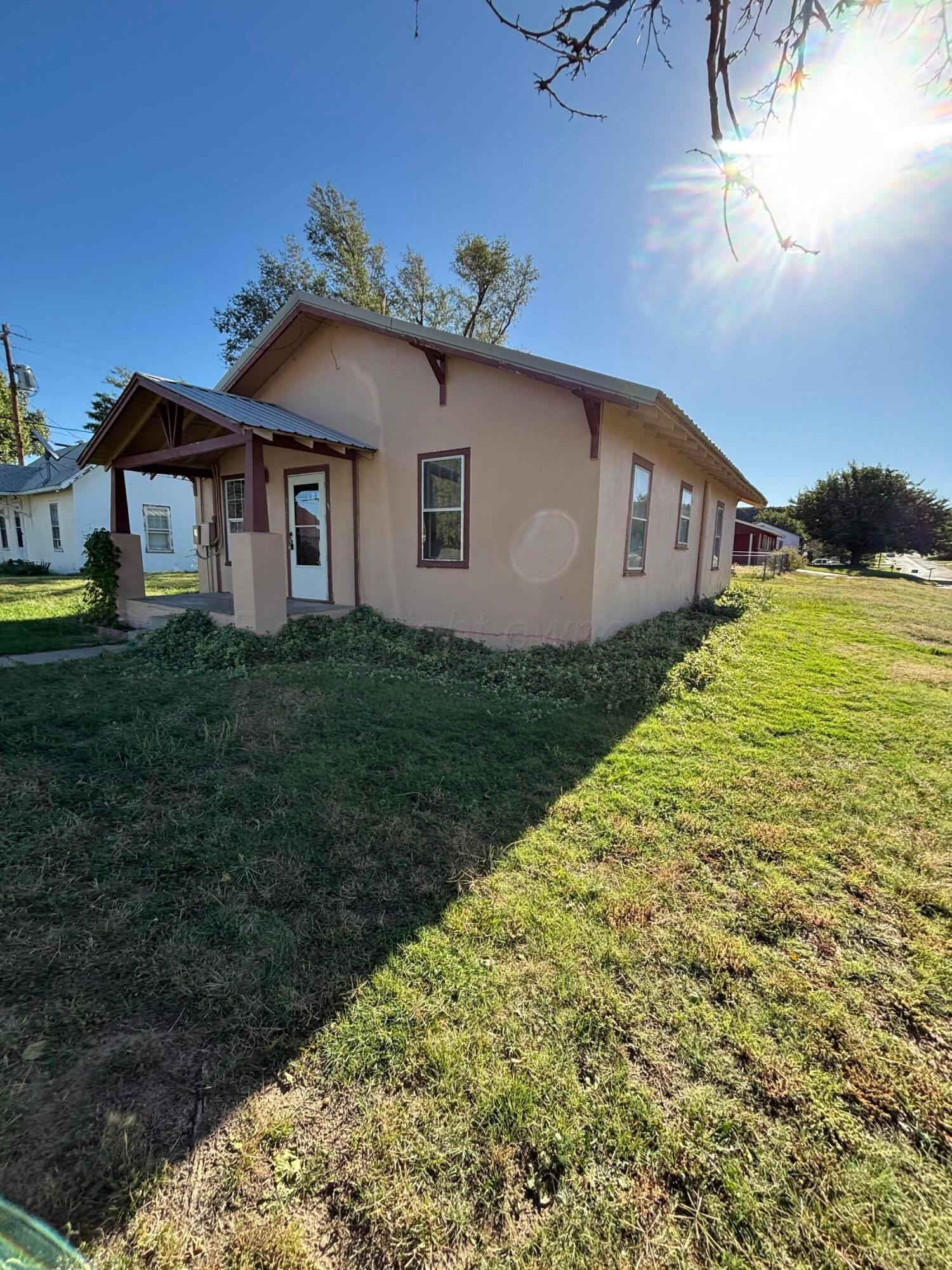 320 West Summit Street Miami, TX 79059 - Photo 5 of 19 a house with green field in front of it