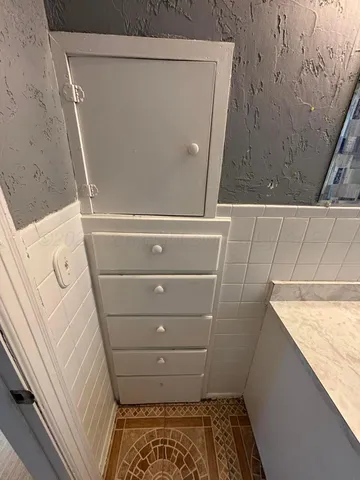 a bathroom with a granite countertop shower and a sink