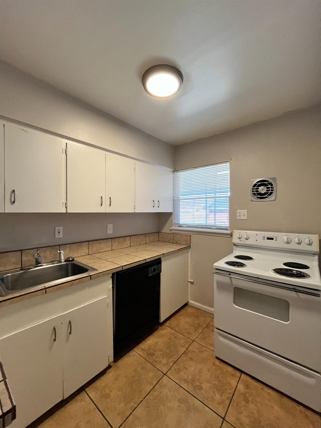 a kitchen with cabinets appliances and a sink