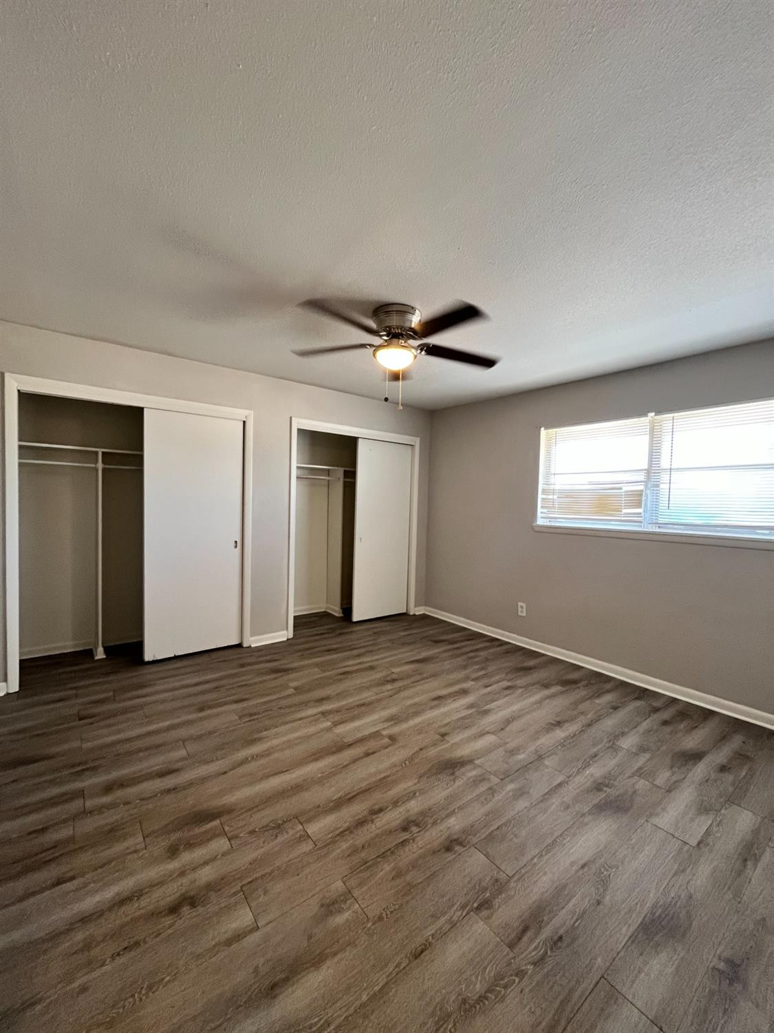 1706 26th Street Lubbock, TX 79411 - Photo 6 of 10 an empty room with wooden floor and windows