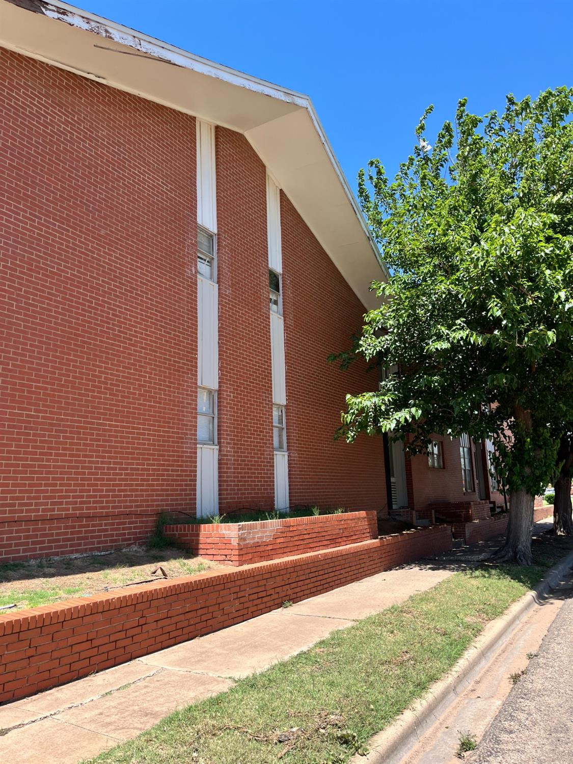 1706 26th Street Lubbock, TX 79411 - Photo 9 of 10 a front view of a house with a yard