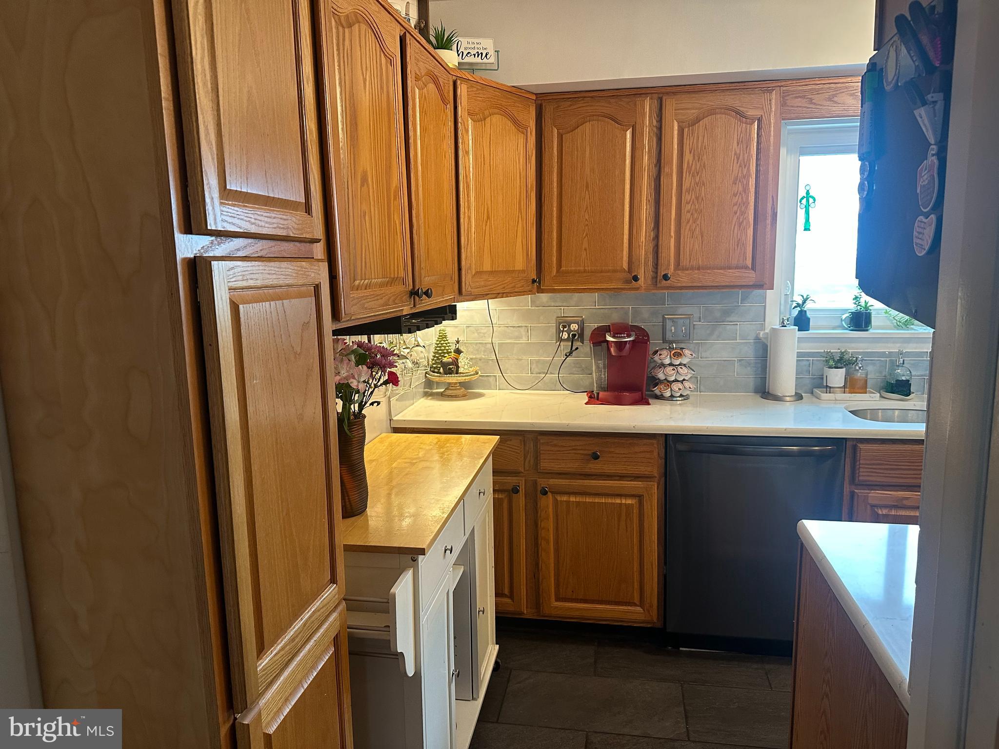 123 Ridge Avenue Centre Hall, PA 16828 - Photo 14 of 37 a kitchen with stainless steel appliances granite countertop a refrigerator a sink and dishwasher with wooden cabinets