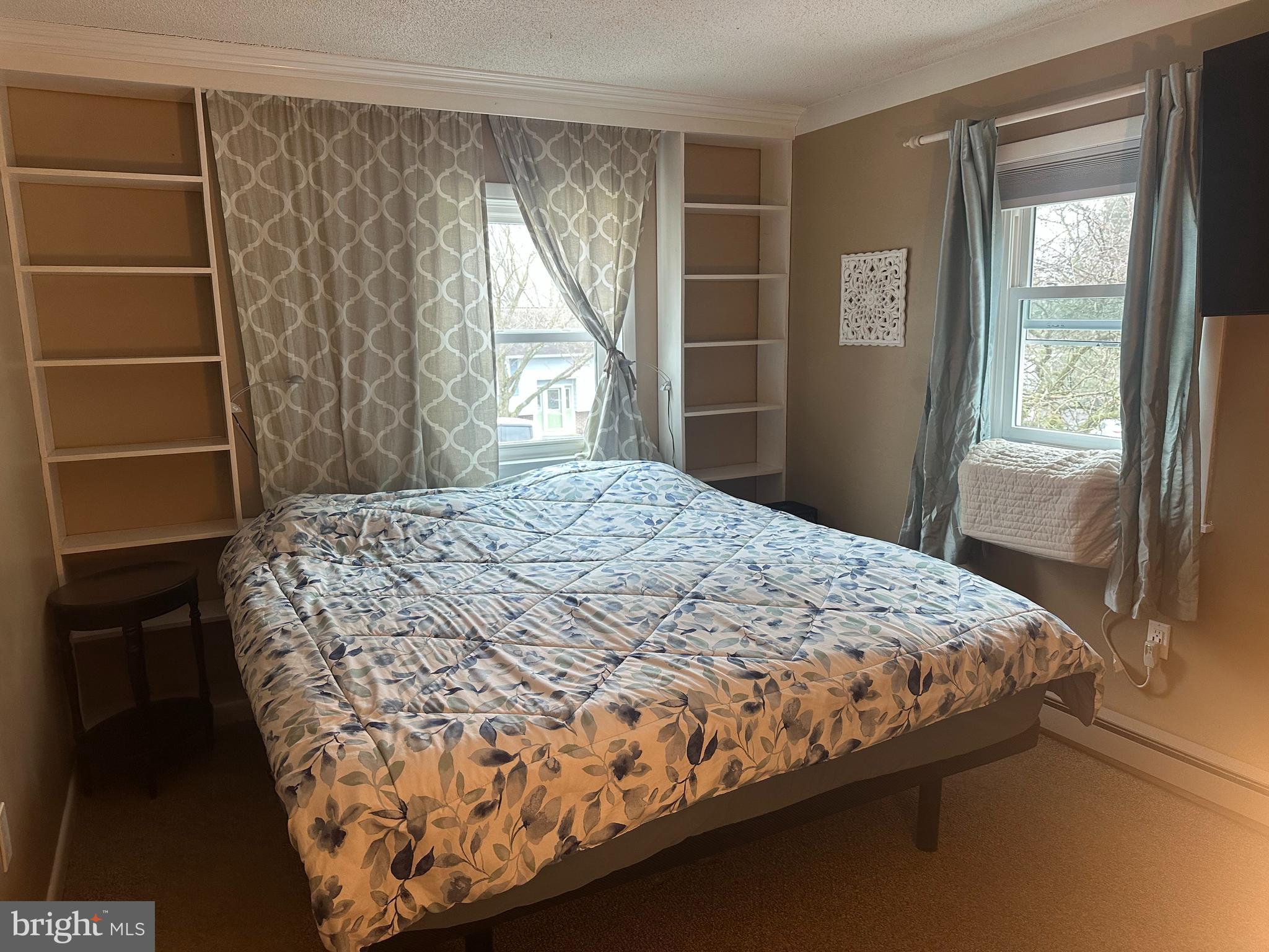 123 Ridge Avenue Centre Hall, PA 16828 - Photo 17 of 37 a bed sitting in a bedroom next to a window