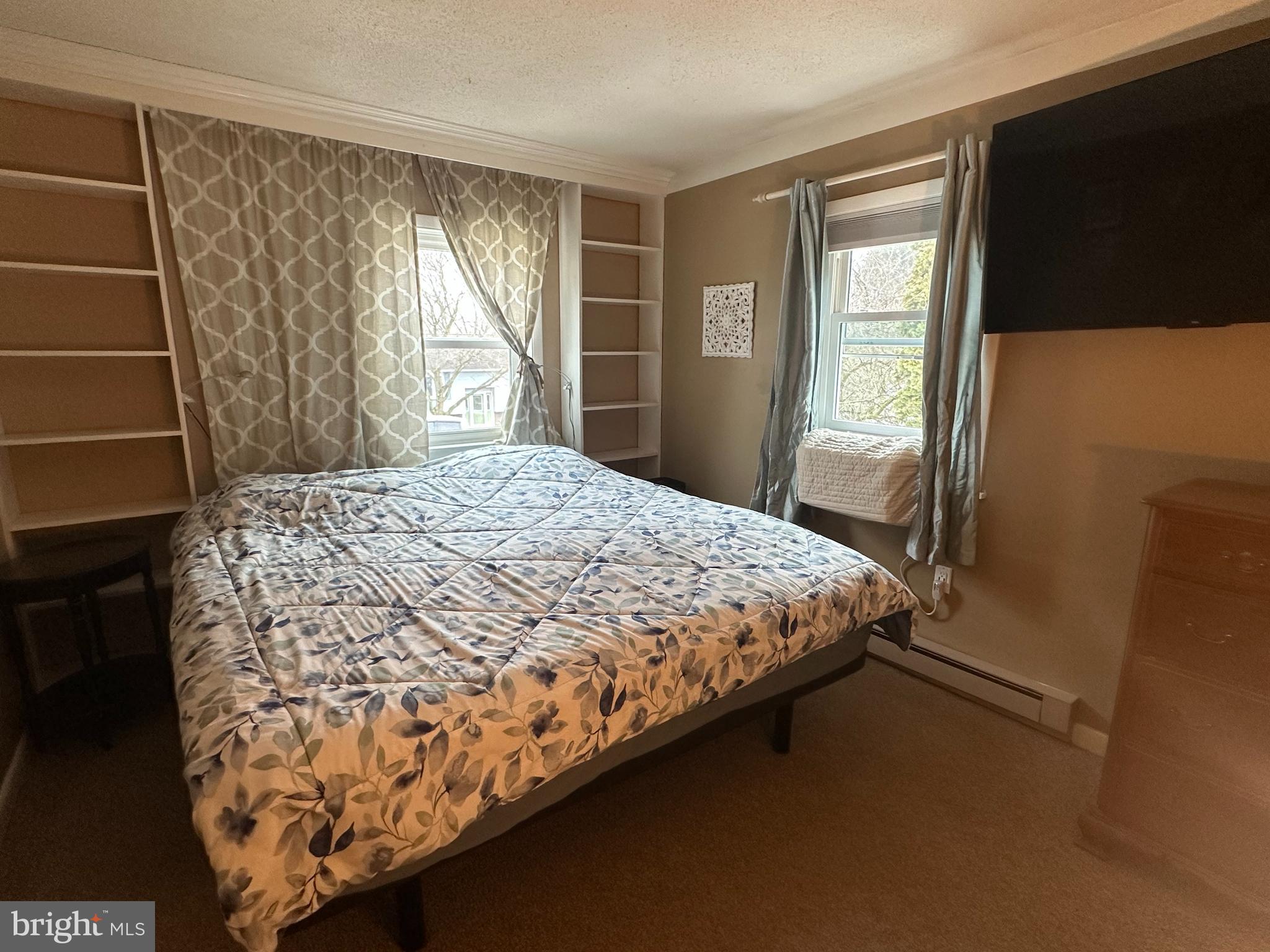 123 Ridge Avenue Centre Hall, PA 16828 - Photo 18 of 37 a bed sitting in a bedroom next to a window