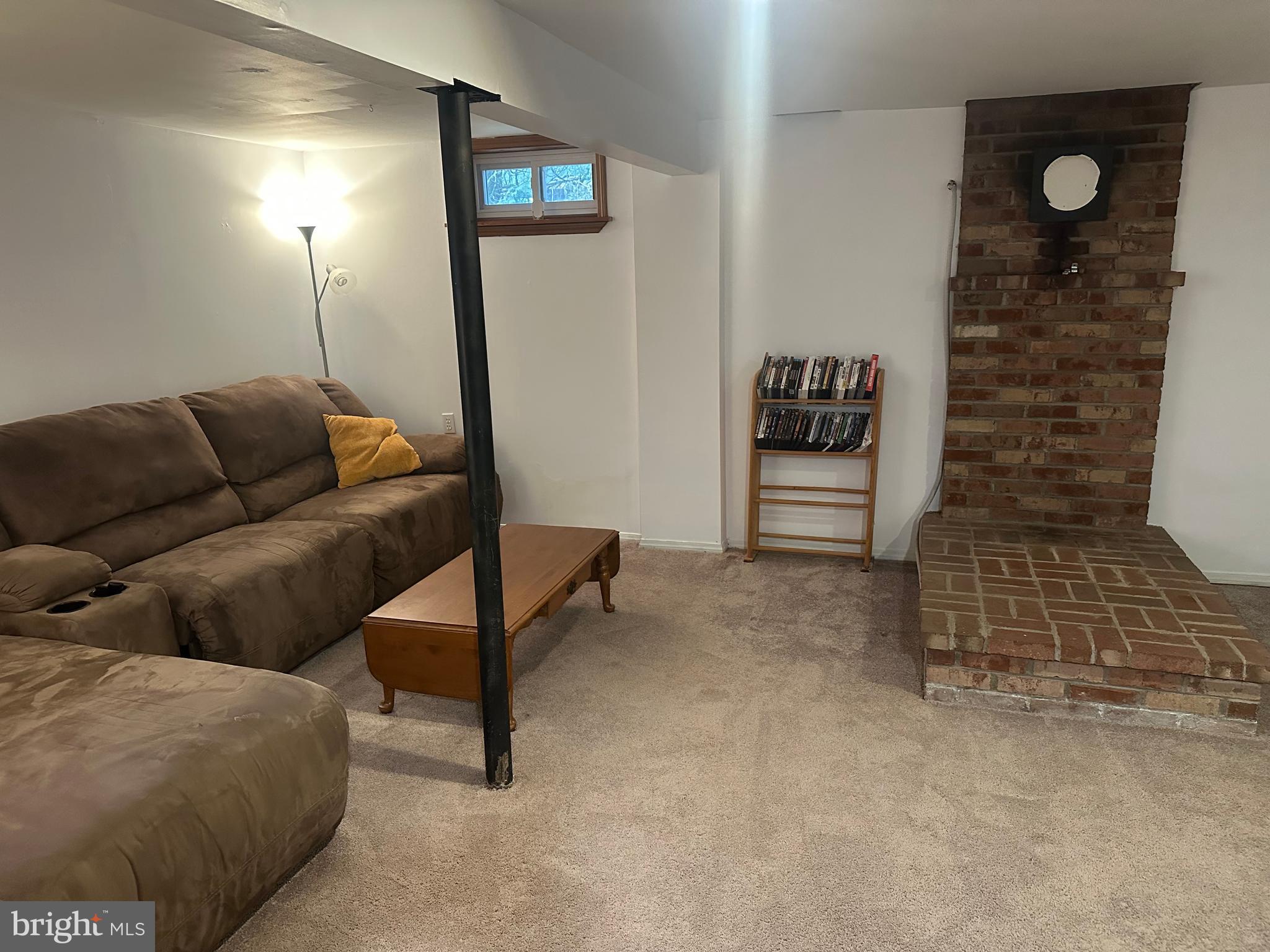 123 Ridge Avenue Centre Hall, PA 16828 - Photo 29 of 37 a living room with furniture and a brick wall
