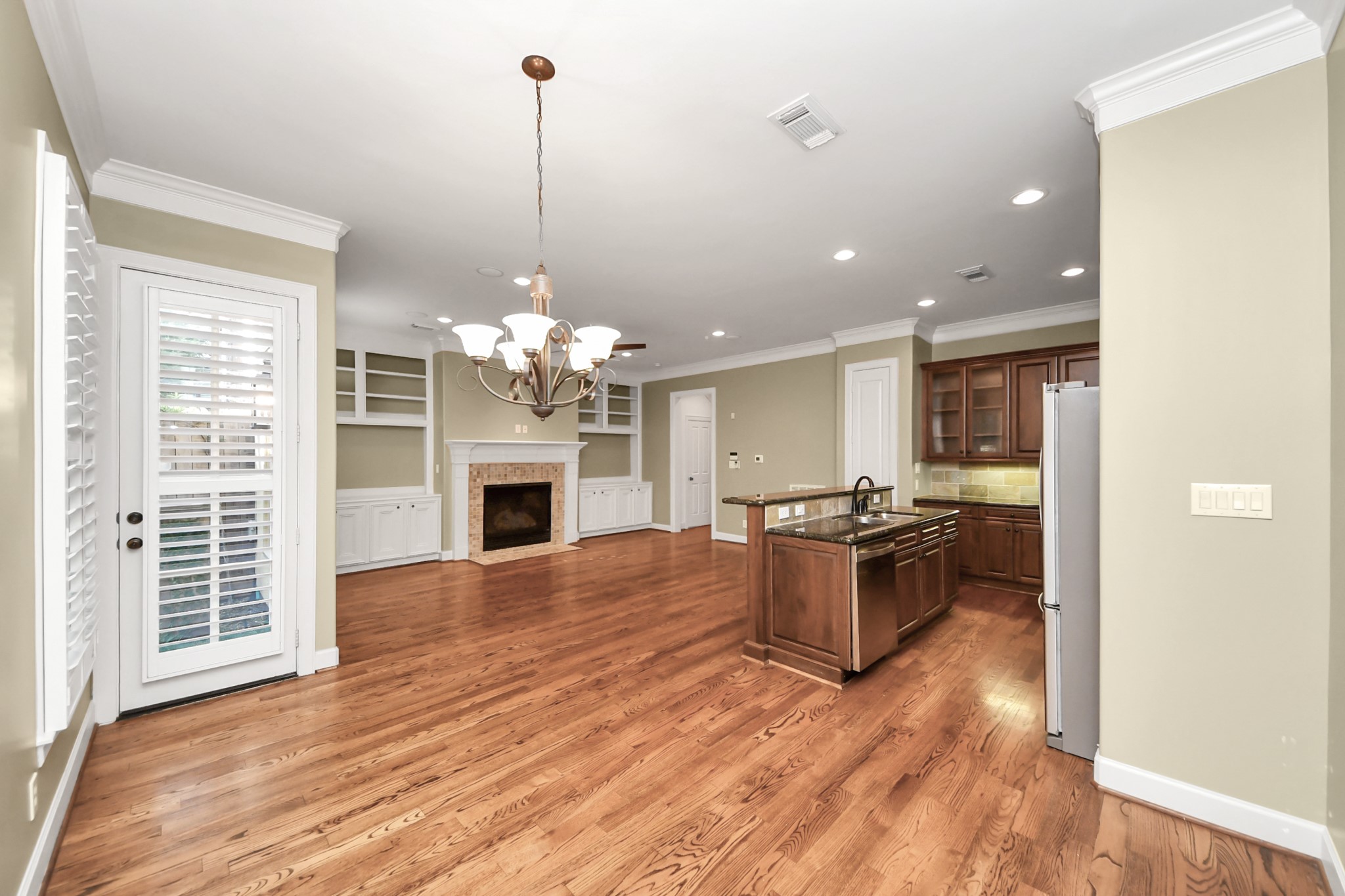 9291 Buffalo Speedway Houston, TX 77025 - Photo 11 of 32 Dining, kitchen, and living areas flow seamlessly, creating an open and connected living space.