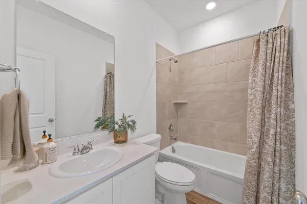 a bathroom with a sink a toilet a bathtub and shower