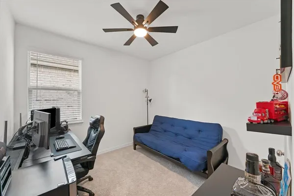 a living room with furniture a flat screen tv and a window