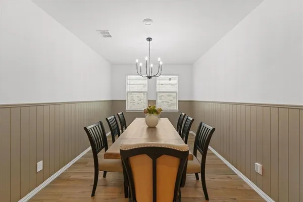 a view of a dining room with furniture wooden floor and chandelier