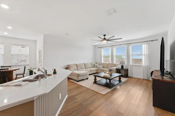 a living room with furniture large window and flat screen tv