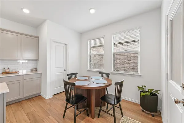 a view of a dining room with furniture and wooden floor